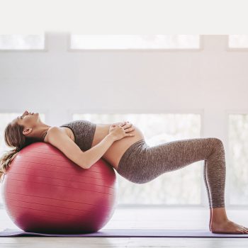 Pregnant woman workout. Beautiful pregnant woman workout. Doing yoga with fitball.